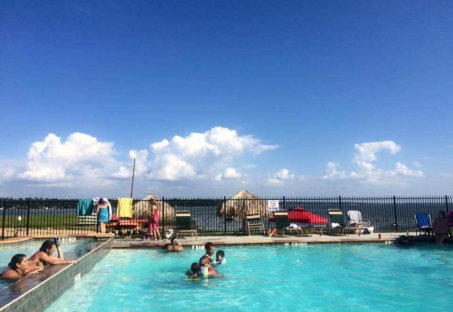 people enjoys swimming on pool under the sun