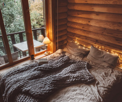 Cozy warm blanket on bed by window